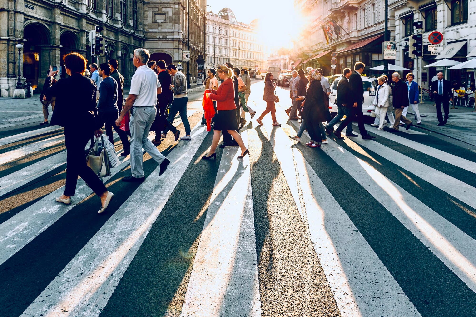 crowd of people crossing the road
