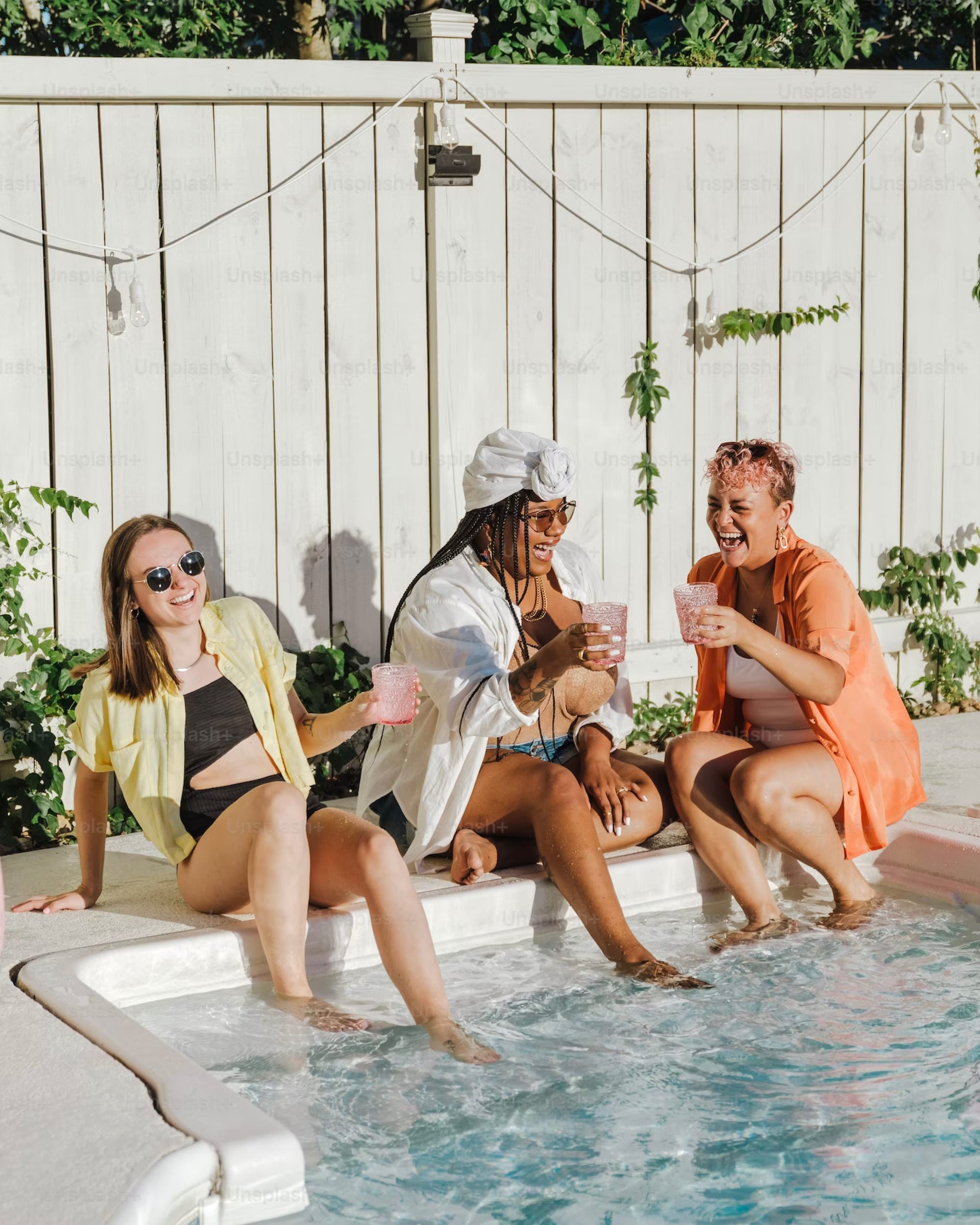 people with their feet in a swimming pool