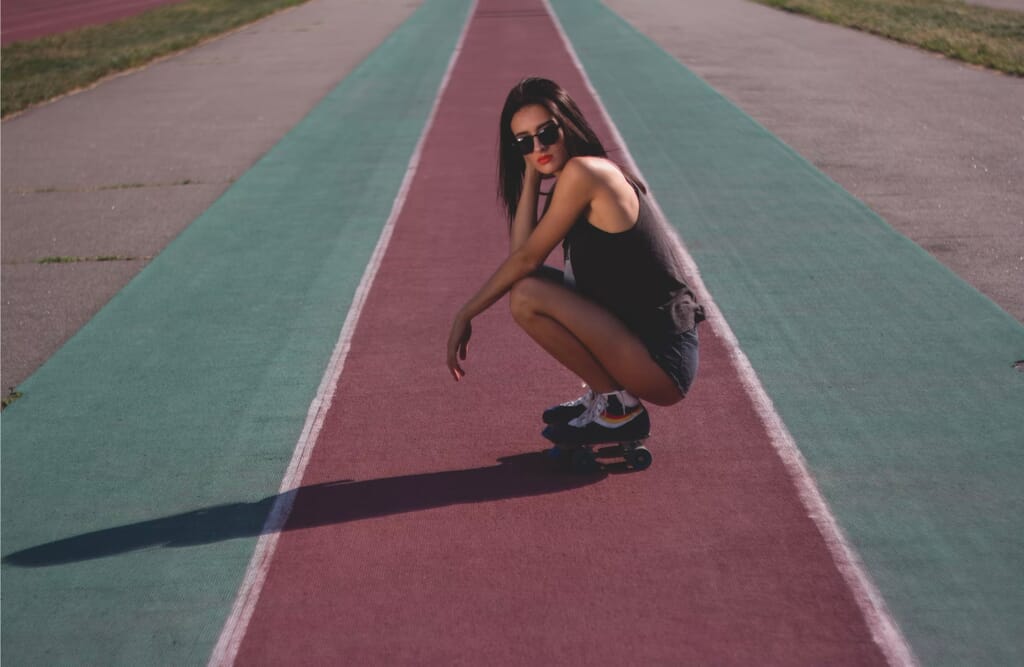 person crouching down on running track