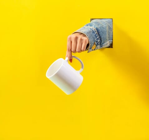 hand holding a mug
