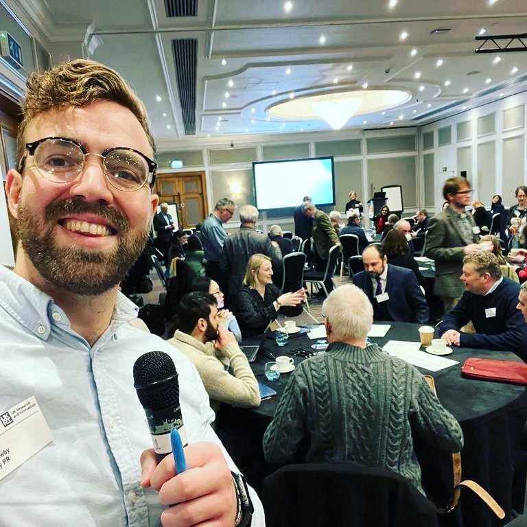 mike newby holding a microphone