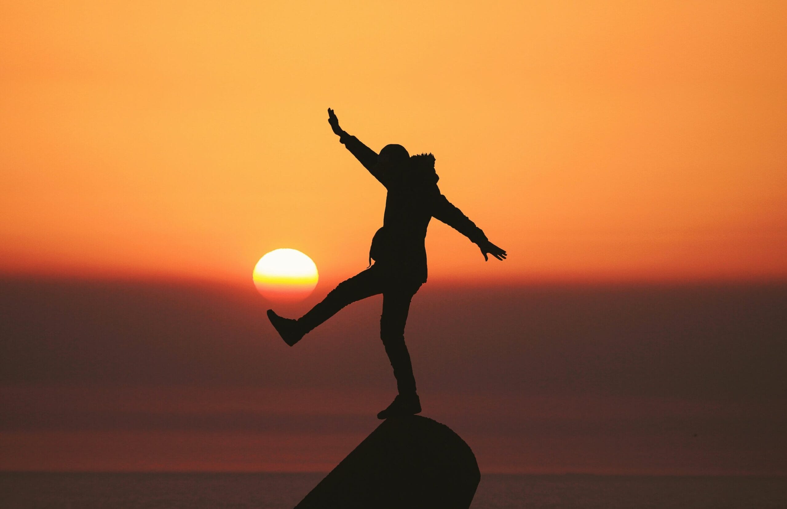 silhouette-kicking-sun-scaled