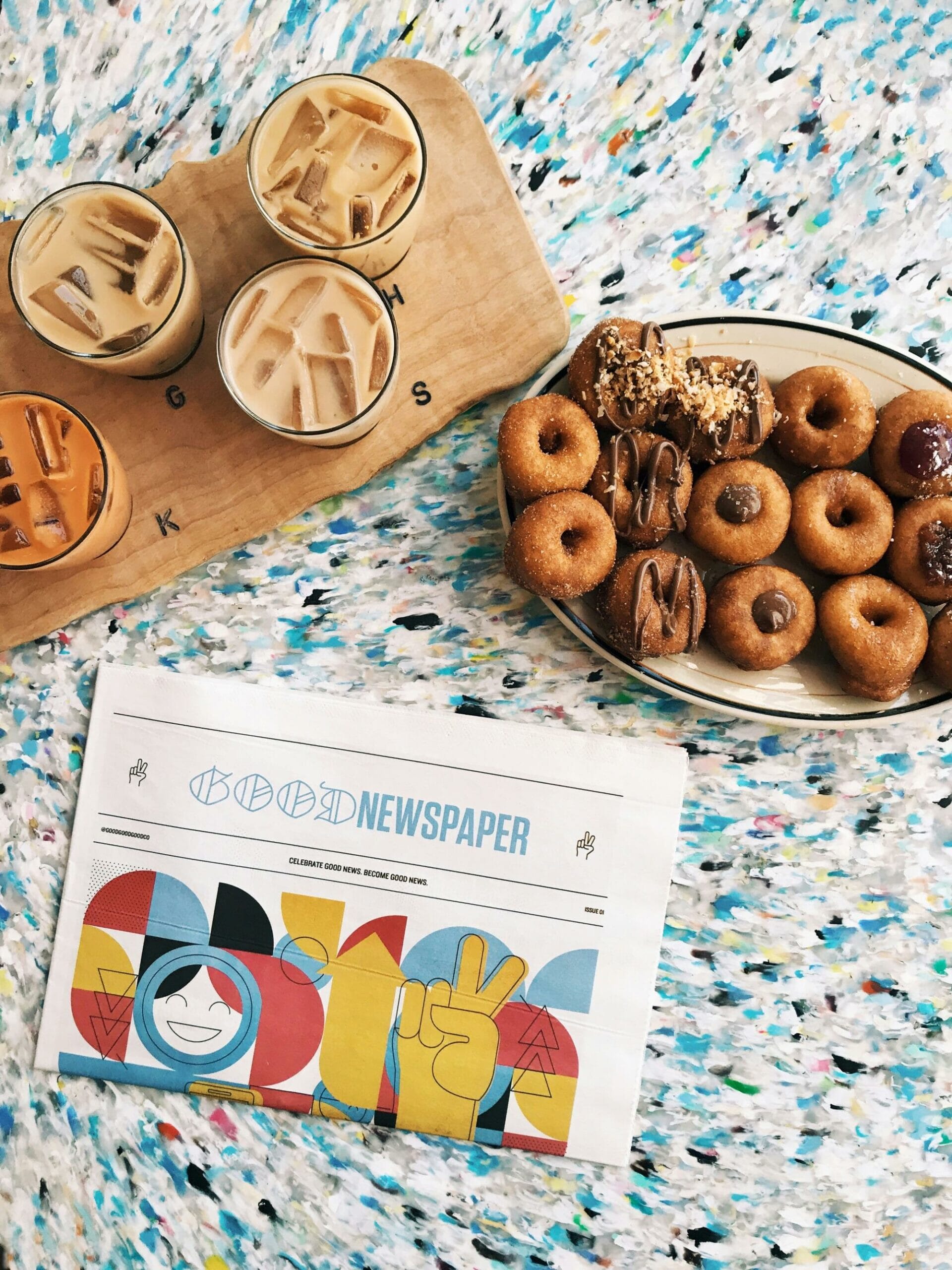 newspaper, doughnuts and iced coffee
